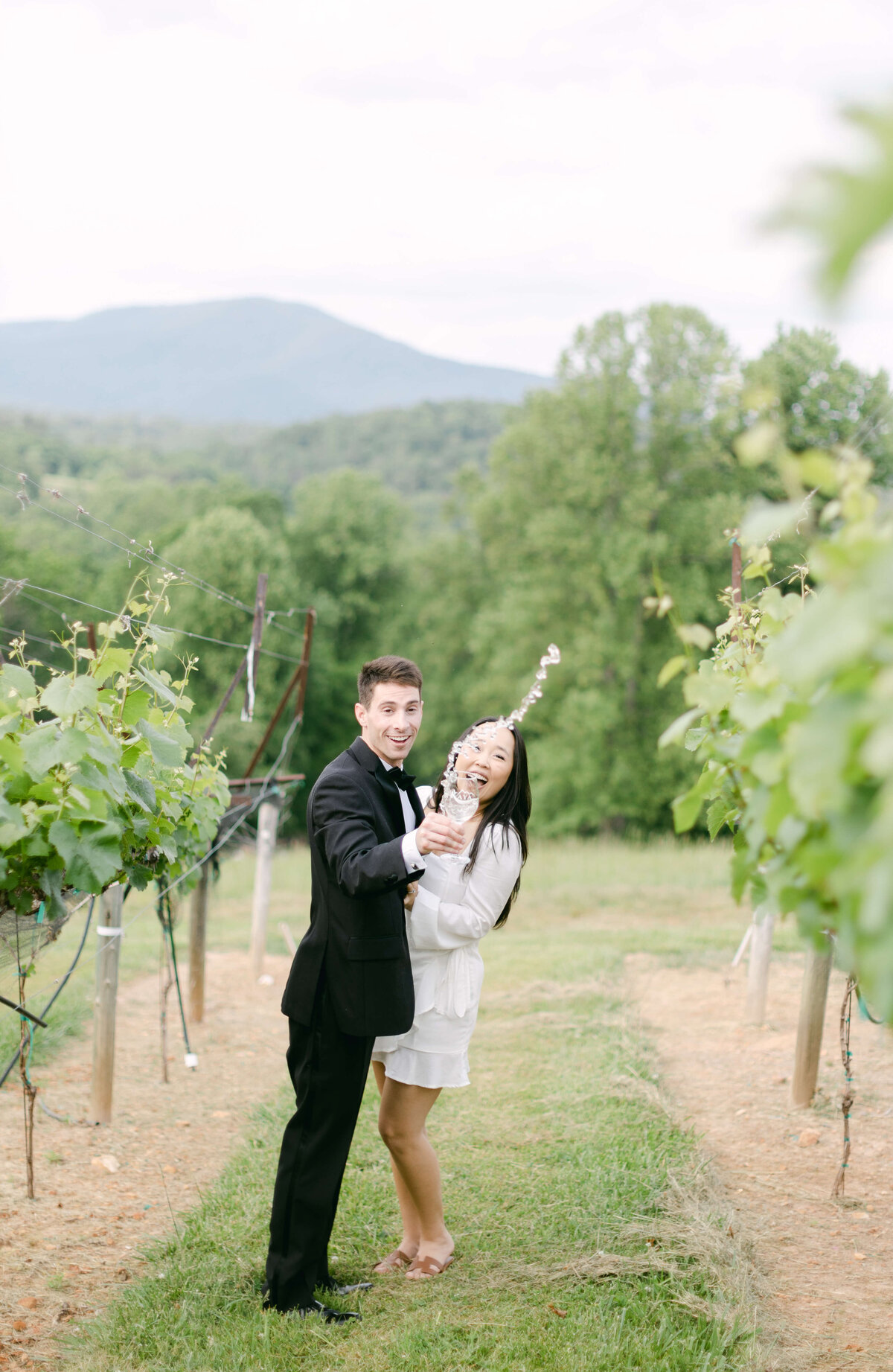A bride and groom throw wine.