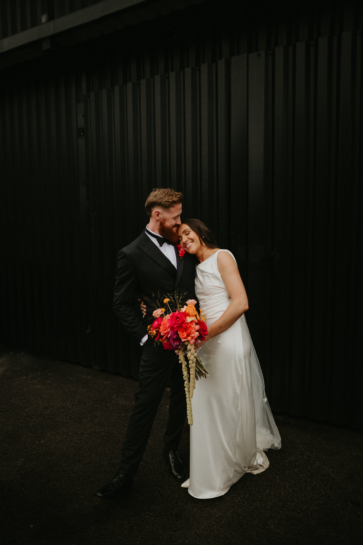 Bride and groom outside The Stables in Manchester on their wedding day. 