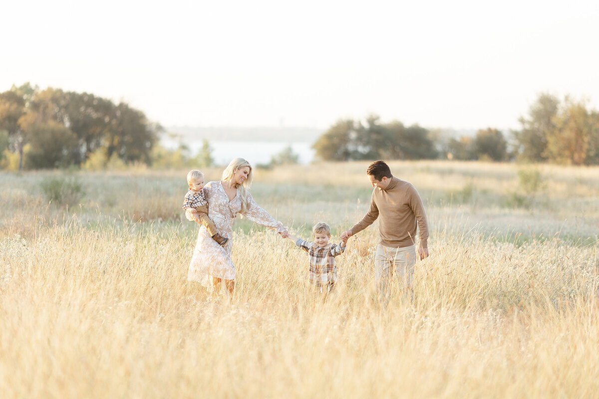 Beautiful Dallas family photo taken of them standing in a field with their children.