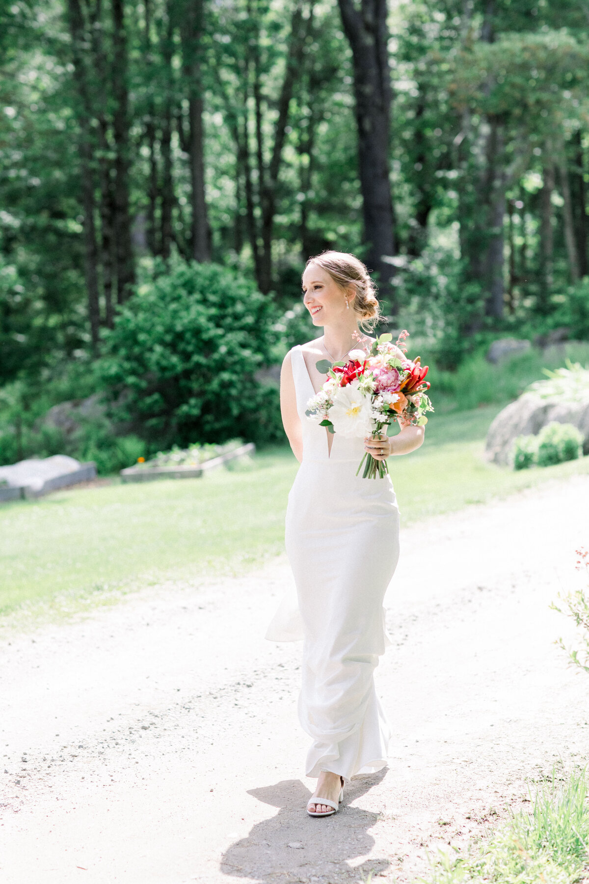 Bride with colorful florals at wedding at Lakefalls Lodge in Munsonville