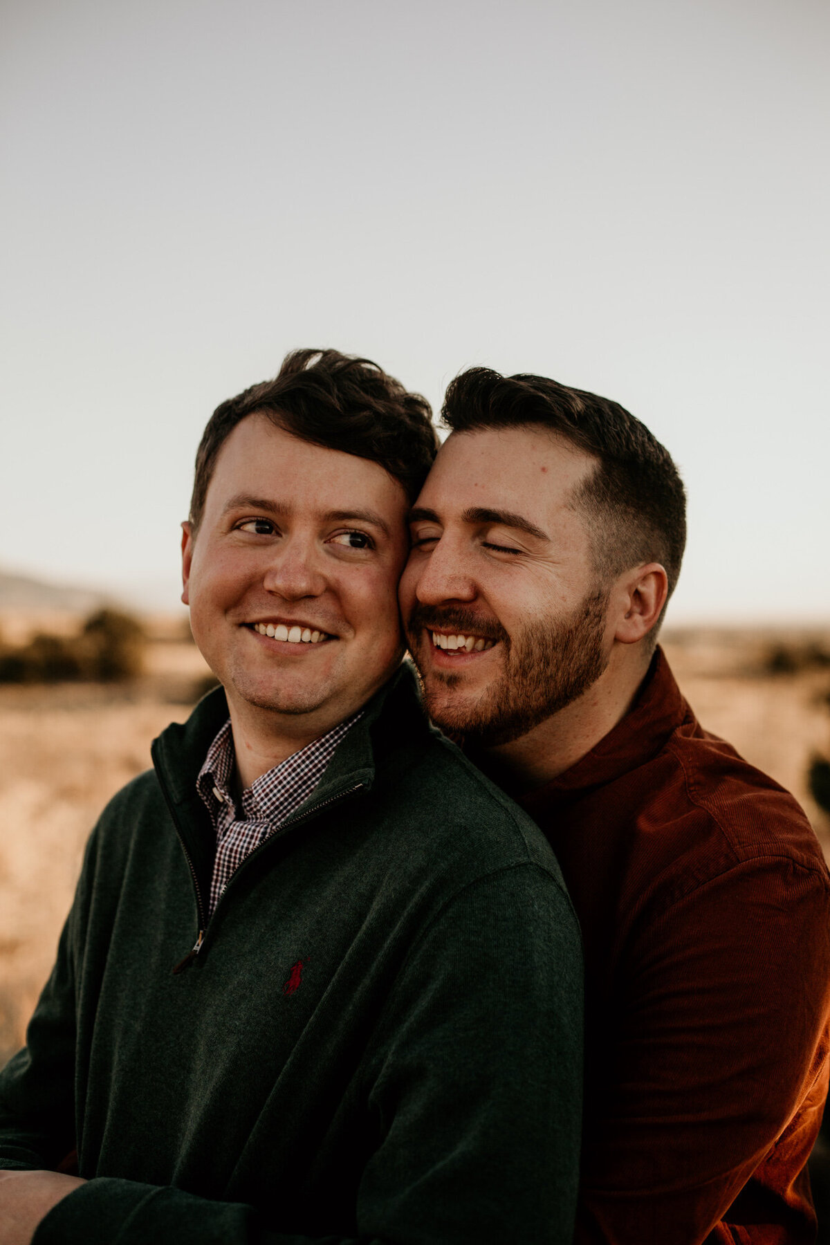 gay couple with their heads touching and laughing