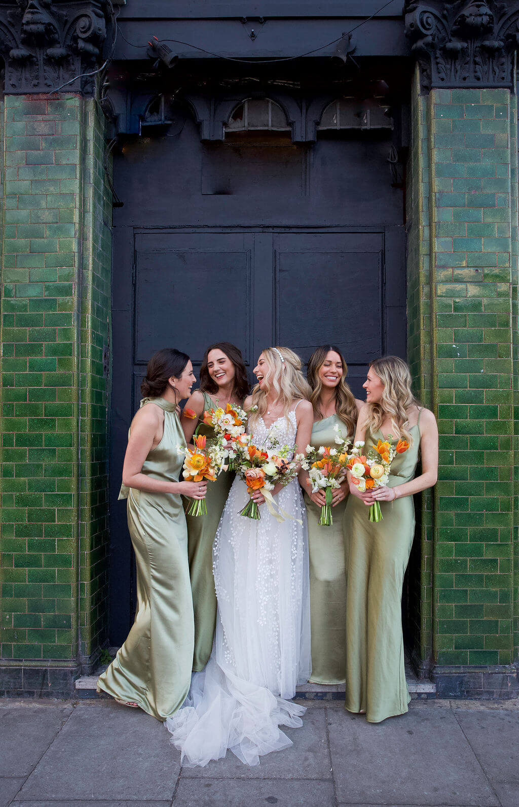 Bride and bridesmaids on street outside The Hackney Co