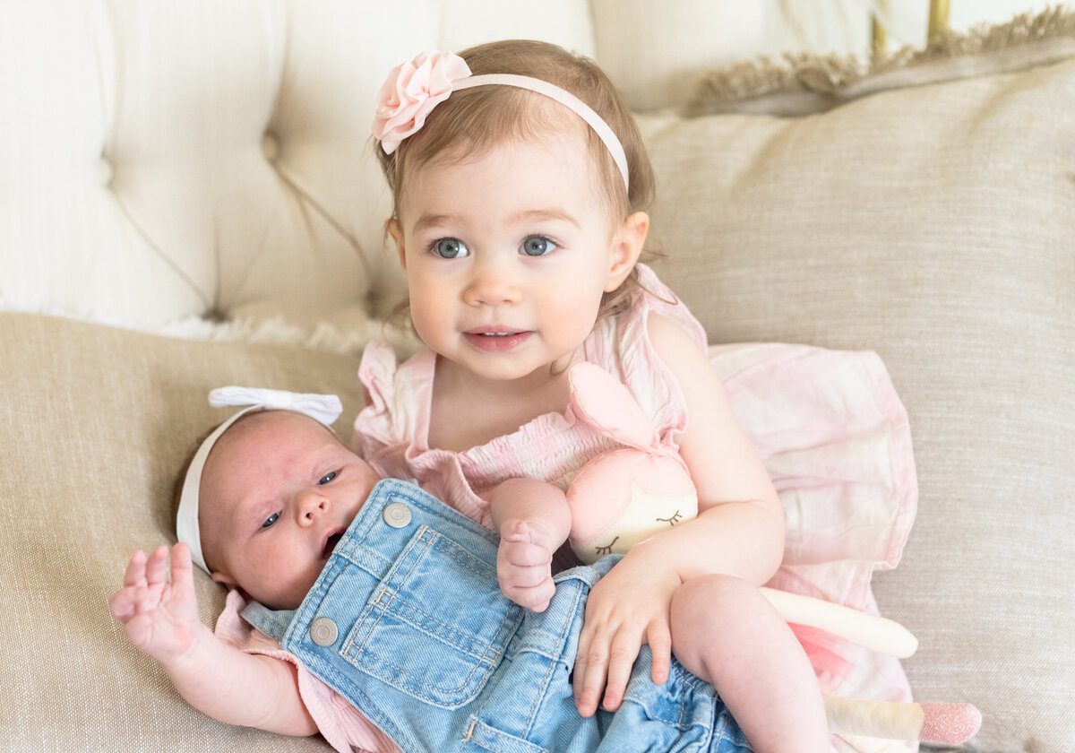 toddler girl with baby girl sister