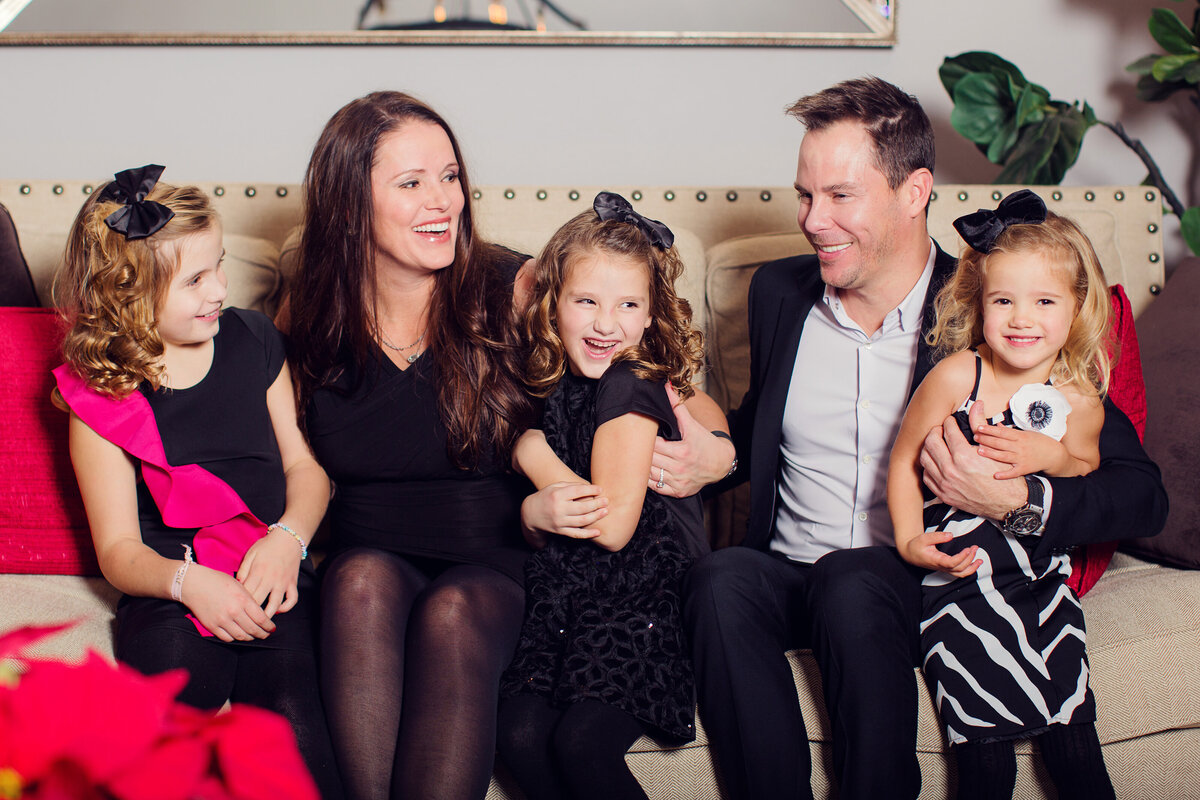 Christmas time for a family of five all dressed up at their home session.