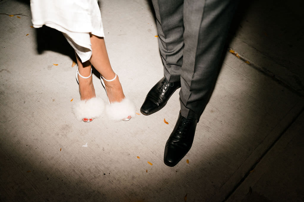 spotlight on the feet of the bride and the groom