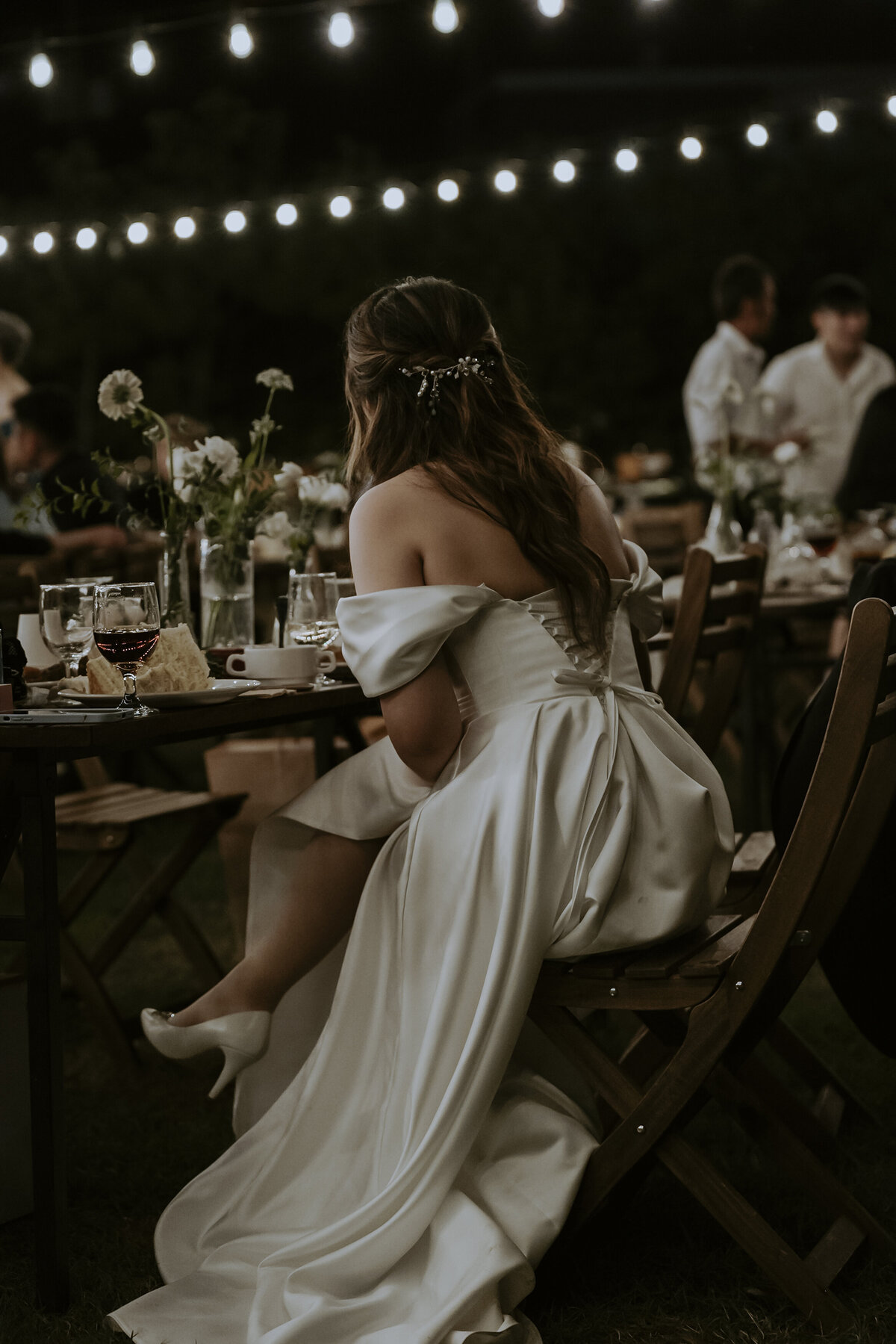 the bride sitting down wearing her wedding dress and while heels