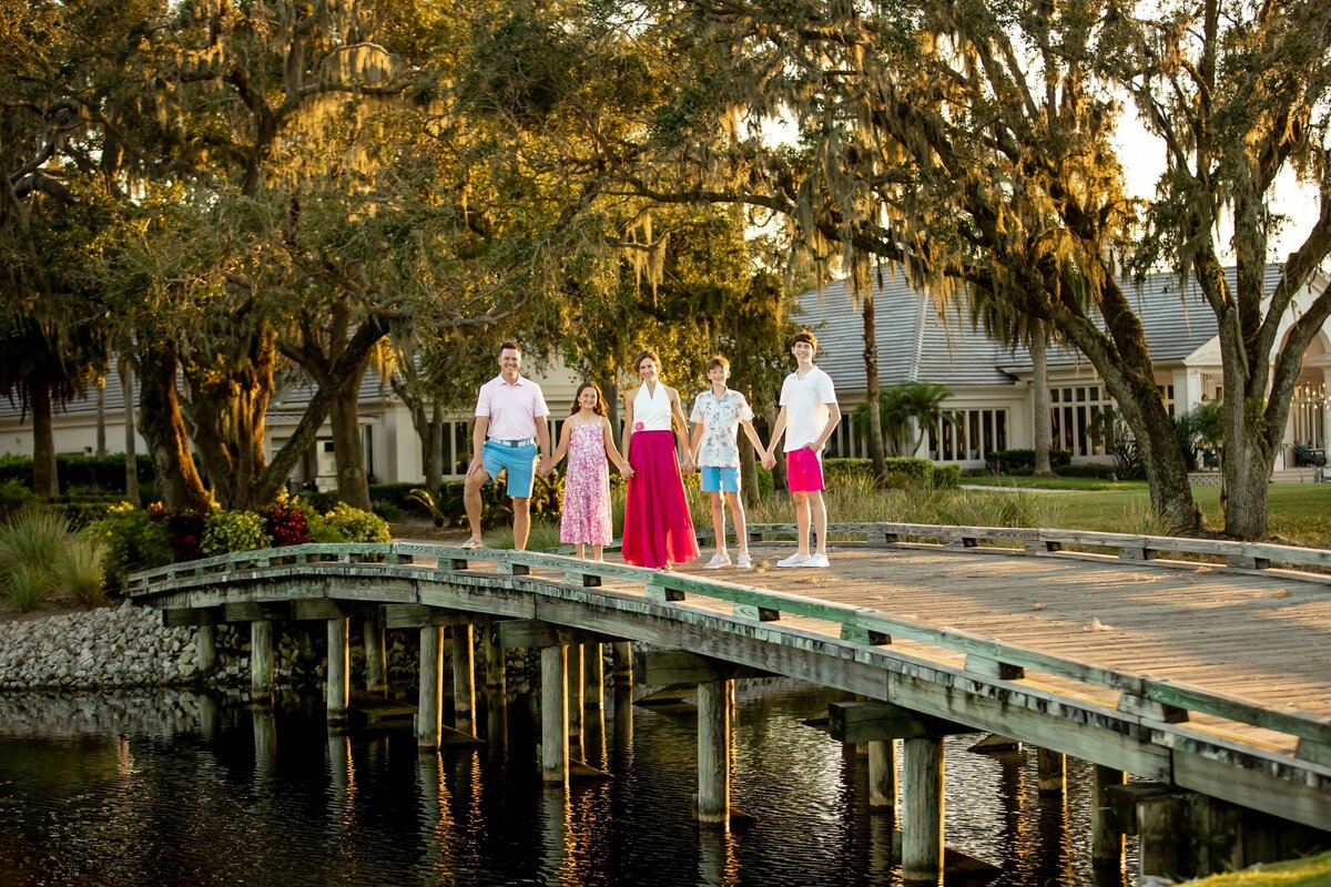 Family photo taken on a golf cart bridge  over a lake in Sarasota