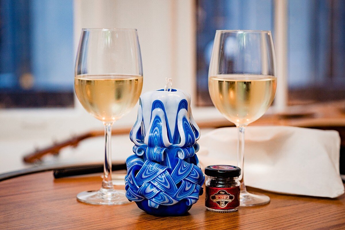 Intricate blue havdalah candle , spices and wine glasses set out for shabbos at a jewish wedding in Nashville at Noelle Hotel