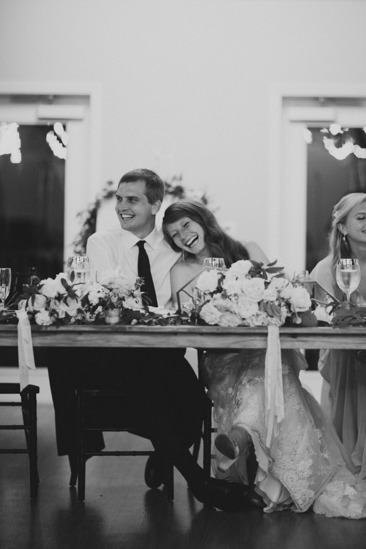 couple laughing during wedding reception