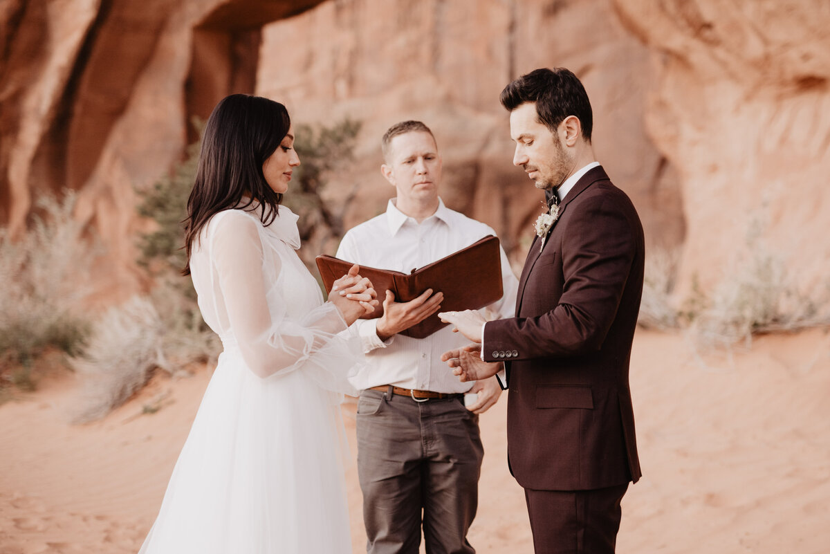 Utah elopement photographer captures bride and groom reading vows
