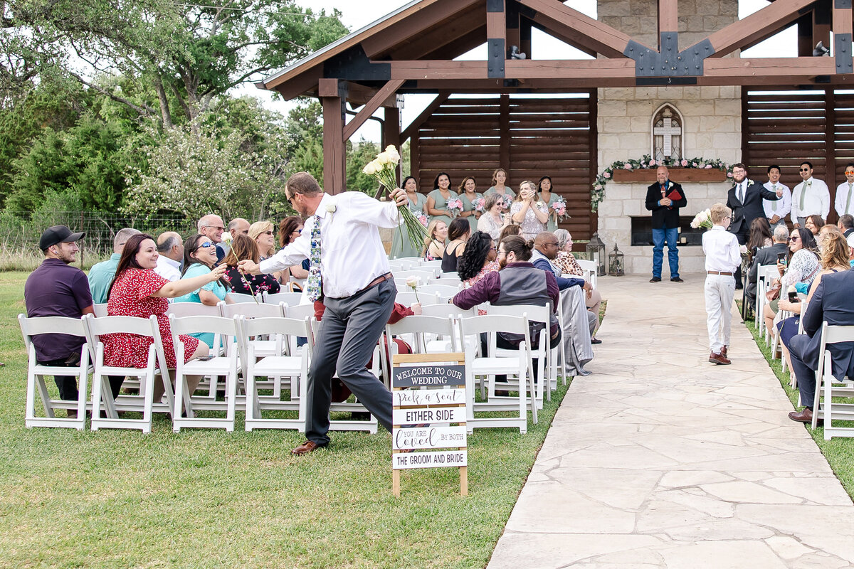 flower man delivers roses to women guests  at Milestone New Braunfels wedding