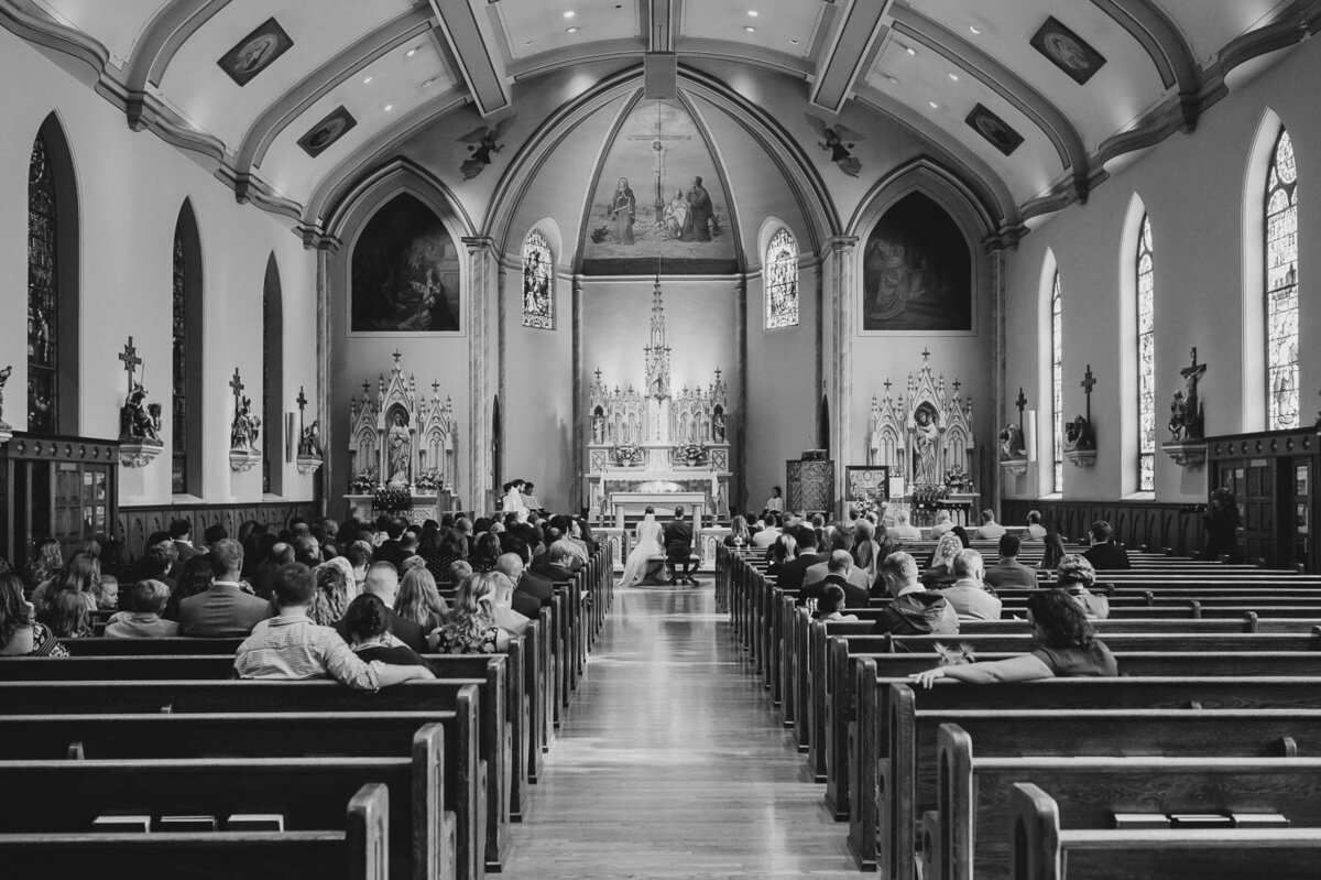 people attending a wedding at a Catholic Church