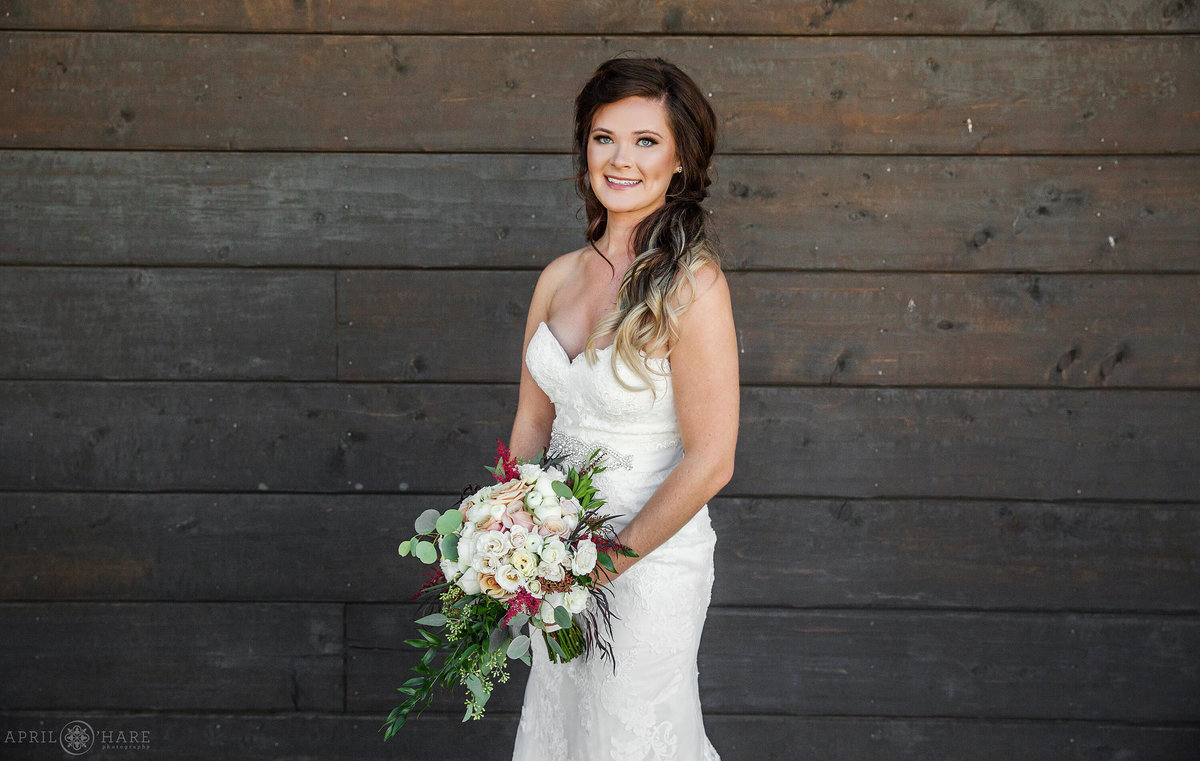 Classic bridal portrait on the wood deck at Frost Eagle Golf Club in the Colorado mountains