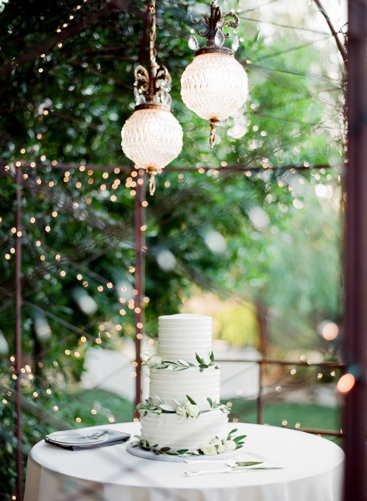 natural outdoor wedding-themed wedding cake decorated on a tabletop.