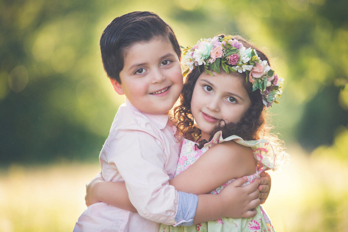 brother-sister-hugging-at-park-sister-with-floral-crown