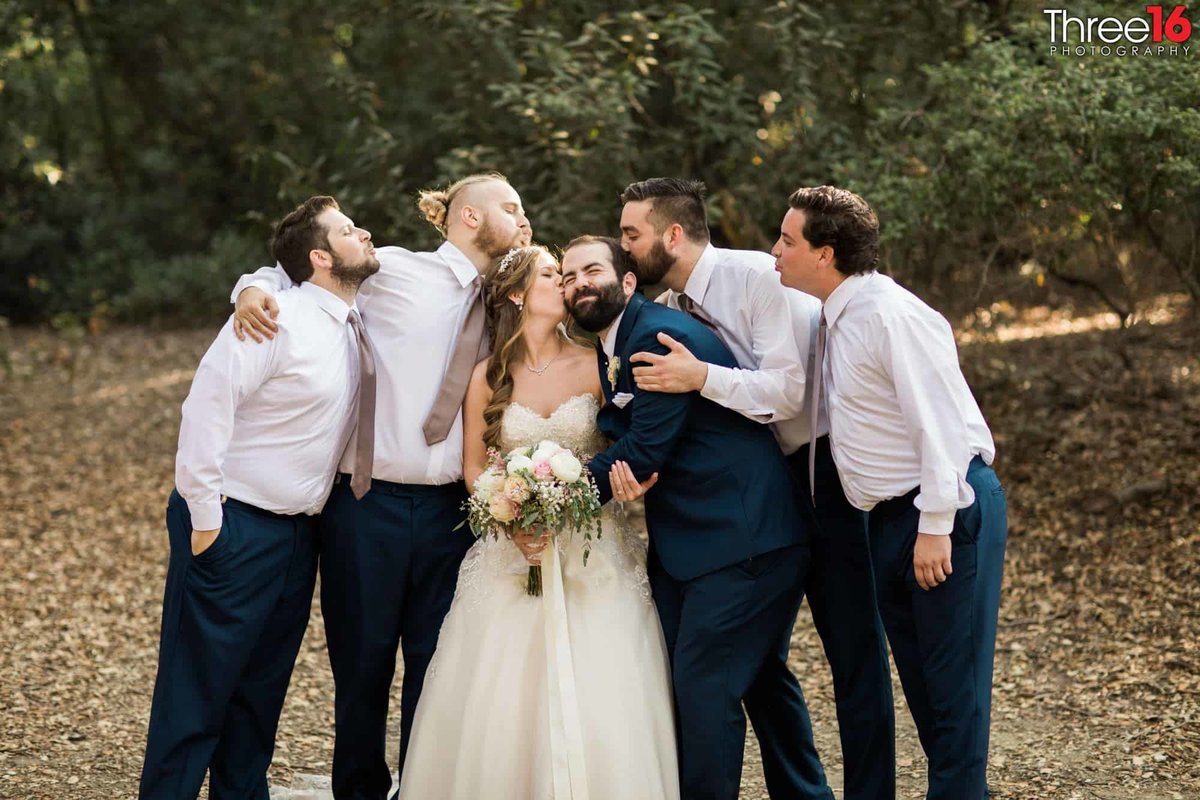 It's all kisses for the Bride, Groom and Groomsmen