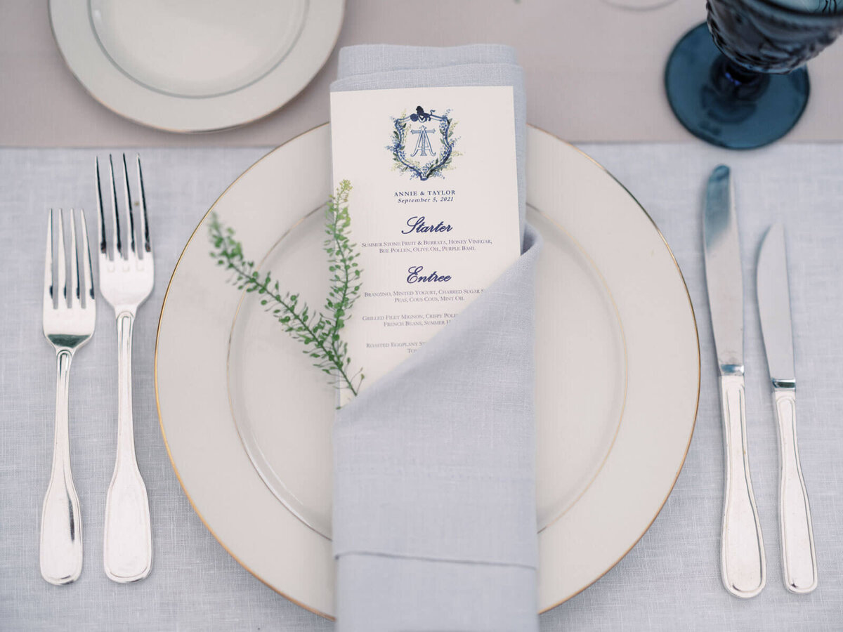 Elegant plate, cutleries, and wedding dinner menu at a dining table at The Lion Rock Farm, CT. Image by Jenny Fu Studio
