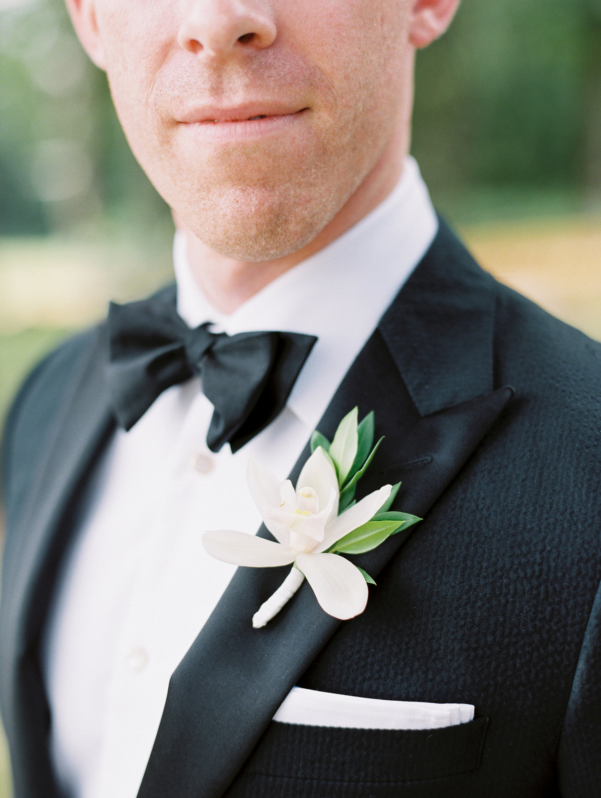 groom's boutonniere made with a lily