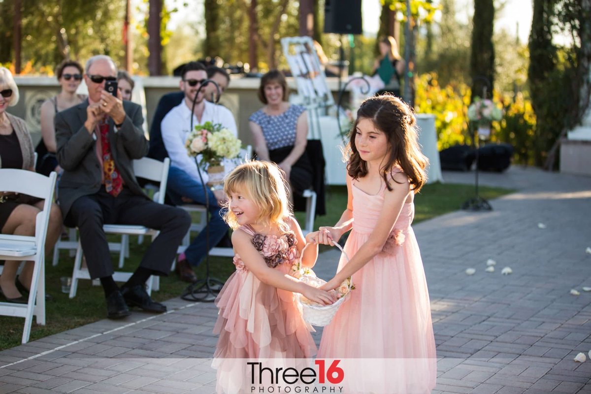 Flower girls line the aisle with rose petals