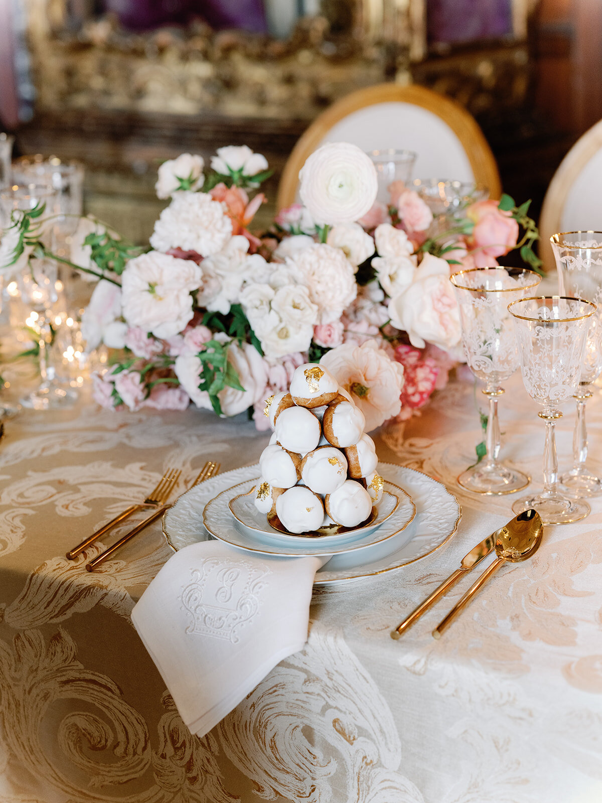 A classic and lavish wedding table setting with blush and gold touches