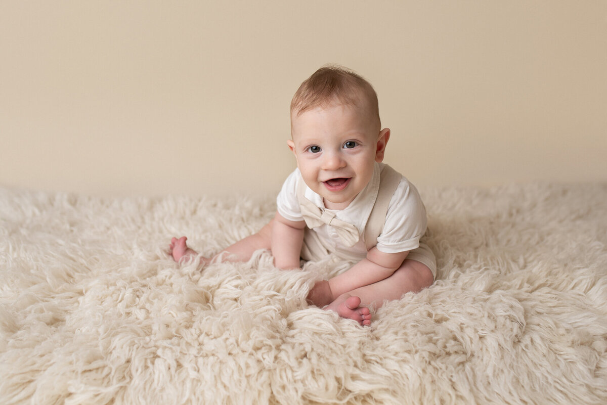 Adorable baby in a cream furry background captured by Laura King, Houston Photographer