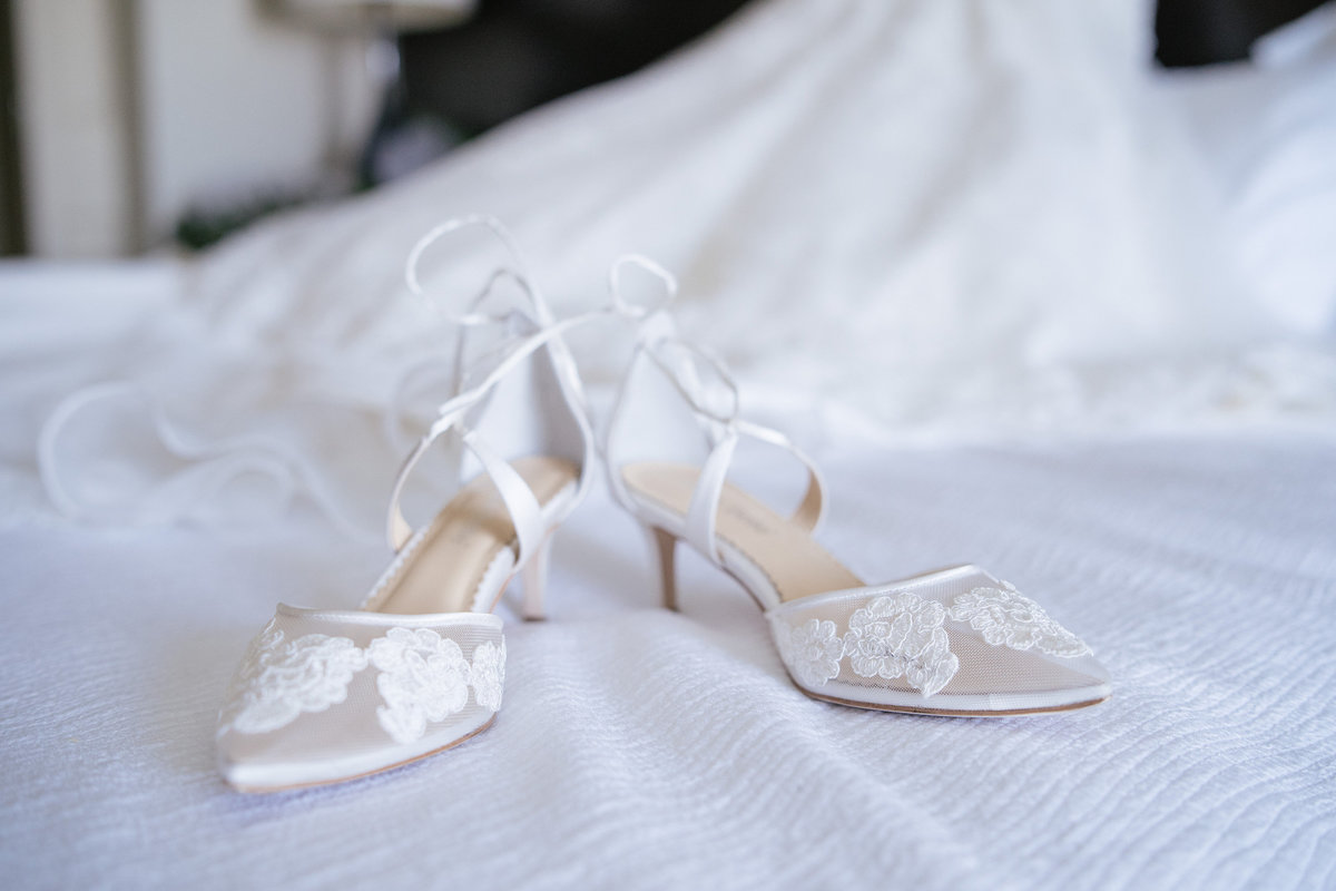 Wedding shoe details during getting ready for ceremony bride put on gown and bridal shoes at hotel Contessa downtown