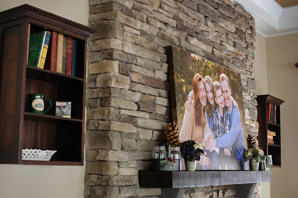 40x30 Gallery Wrapped Canvas Print featuring a family portrait displayed on a wood mantle fireplace, showcasing the scale, texture, and warm tones of the custom wall art in a home setting.