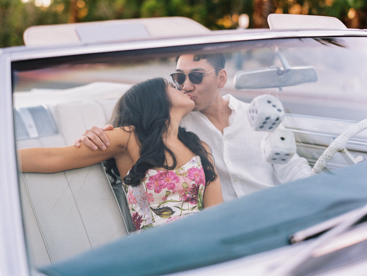 couple in a vintage car kissing in palm springs