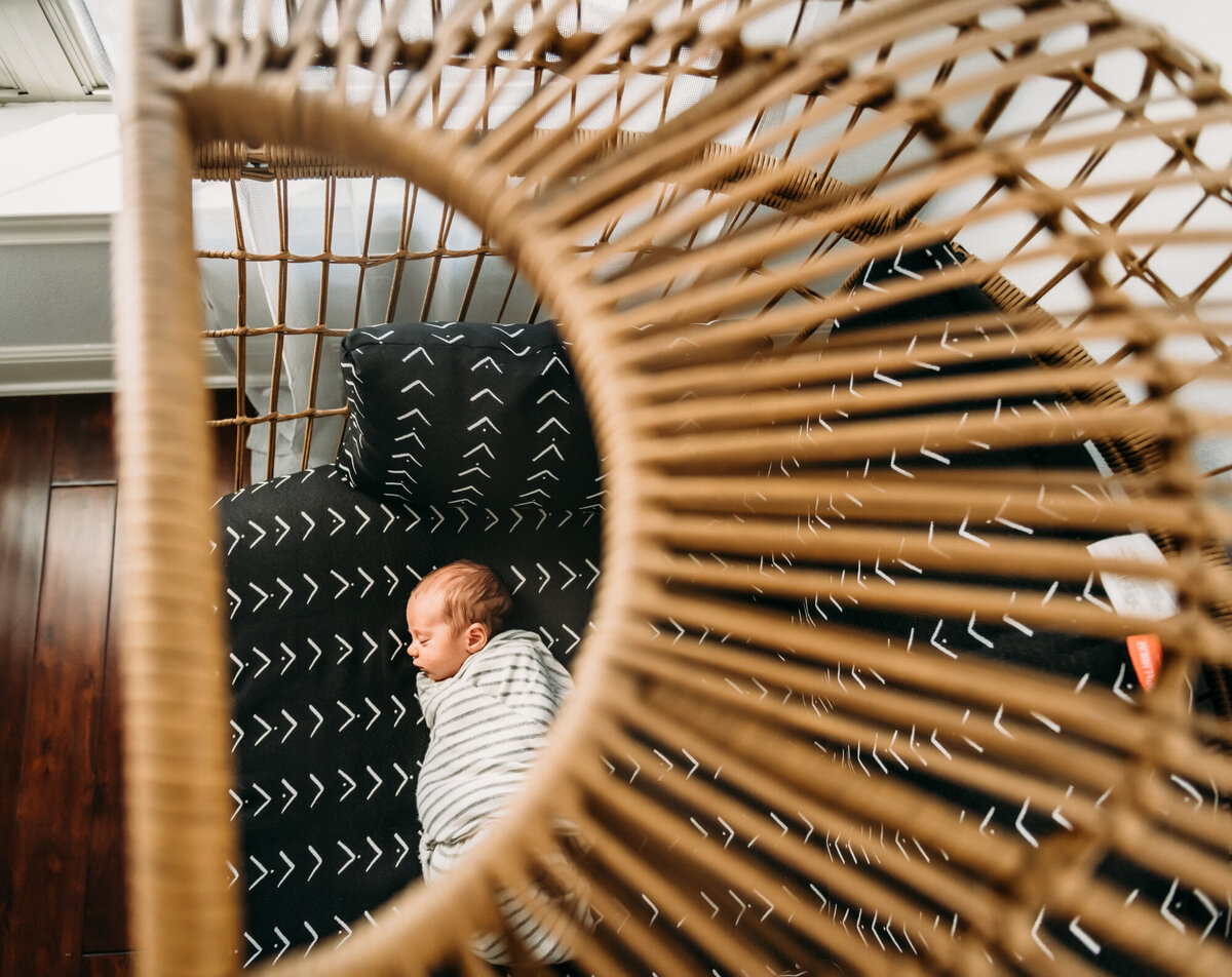 Newborn Photographer, Baby is sleeping on an egg chair.