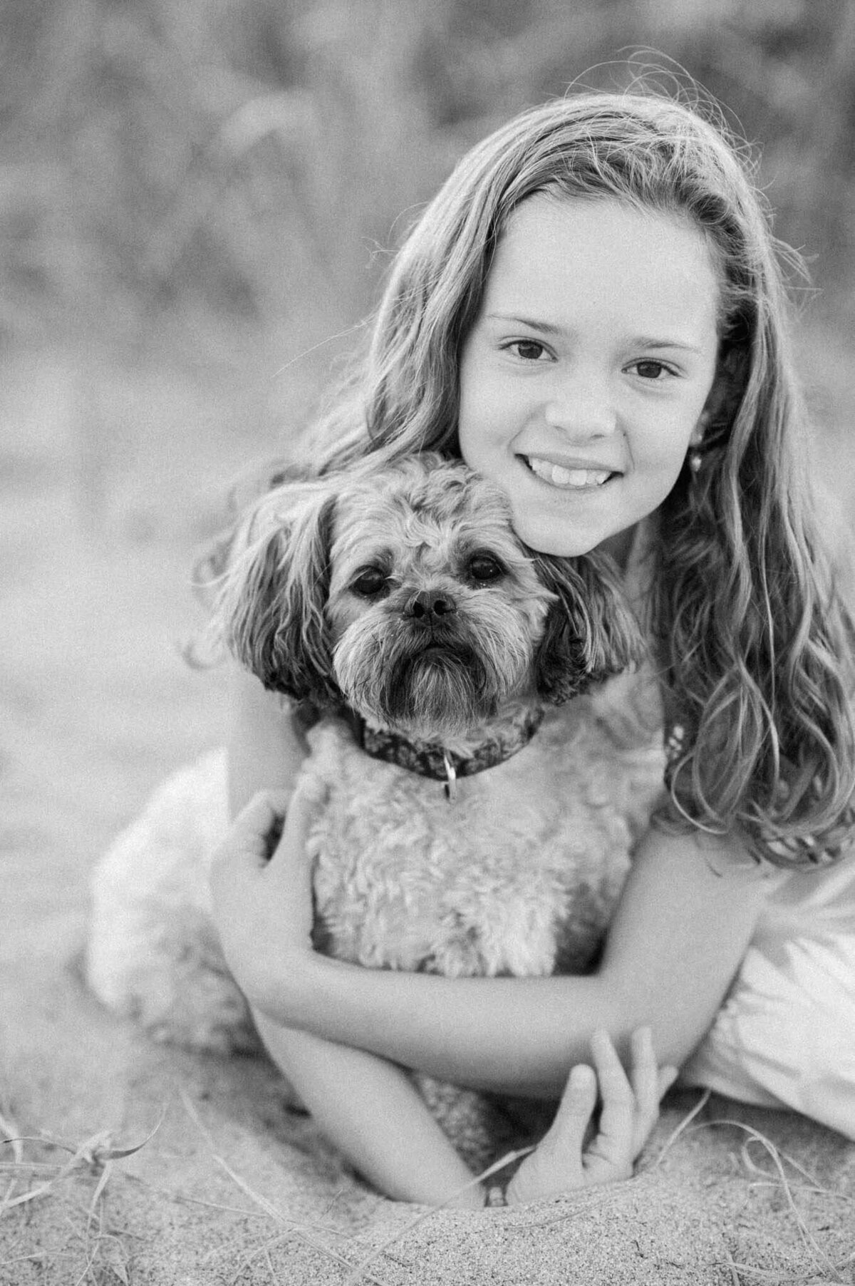 little girl and her dog on the beach By Carrie Pellerin