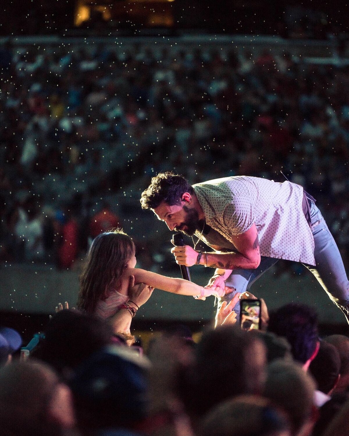 Matthew Ramsey singing to fan in rain during Old Dominion concert