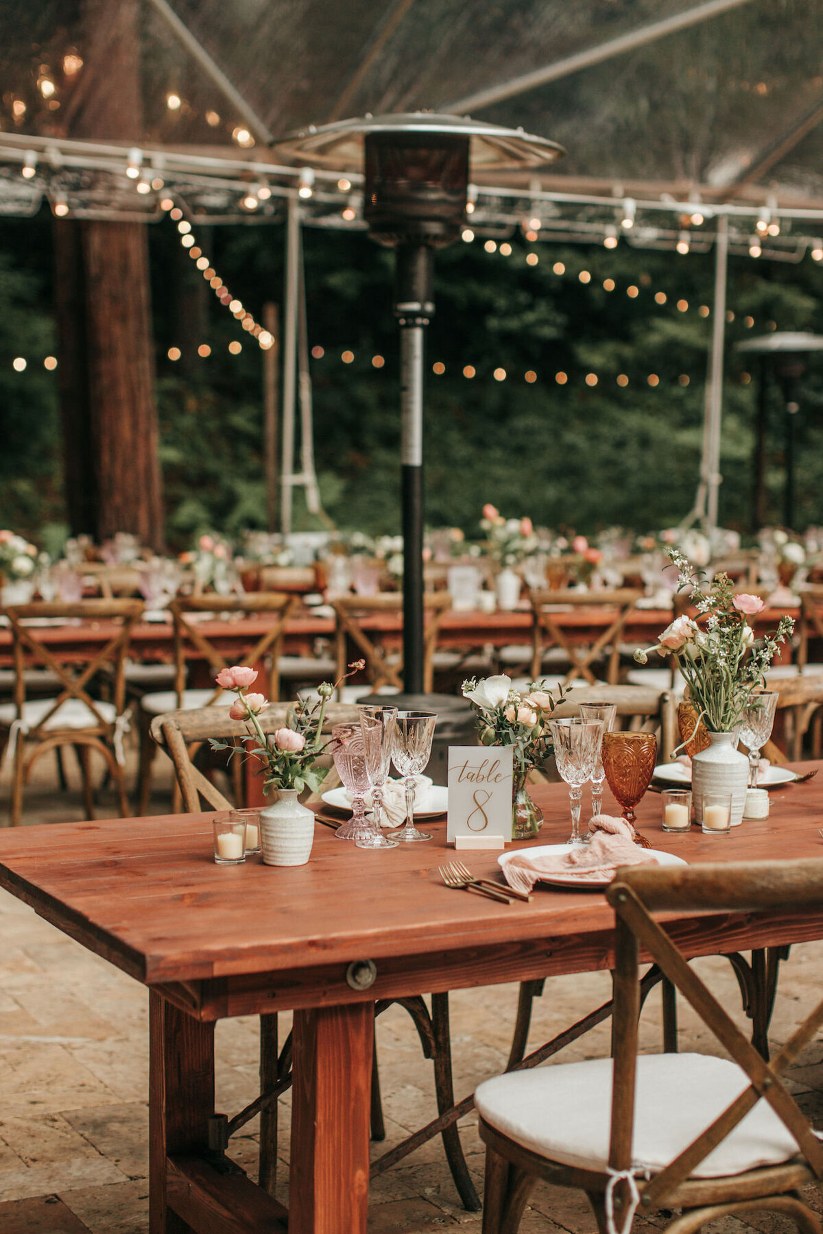 Rows of tables for a redwood forest wedding with blush tones