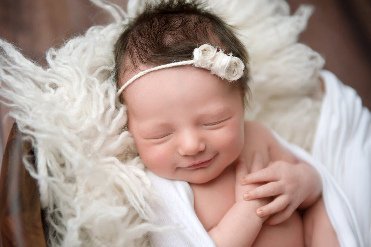 Newborn session of baby girl in a bow