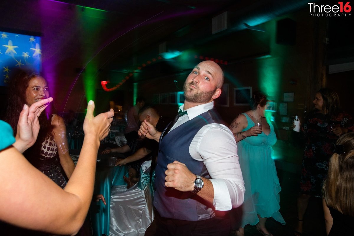 Male guest dancing at a wedding reception