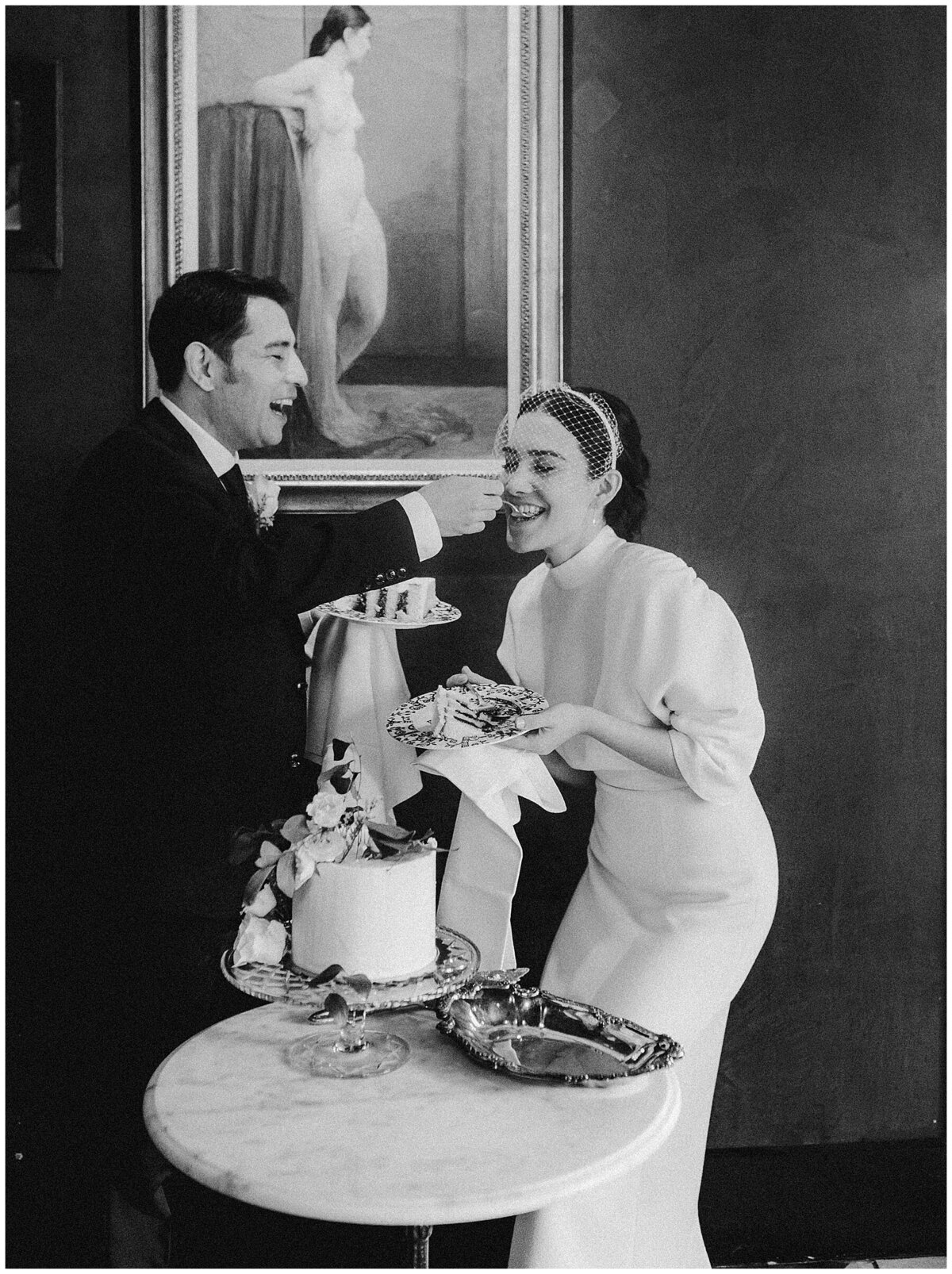 Bride and groom sharing wedding cake at Hotel Saint Cecilia Elopement Austin