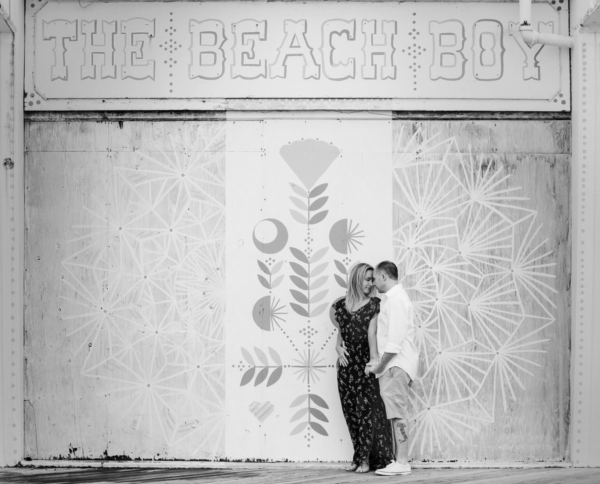engaged couple by mural in asbury park