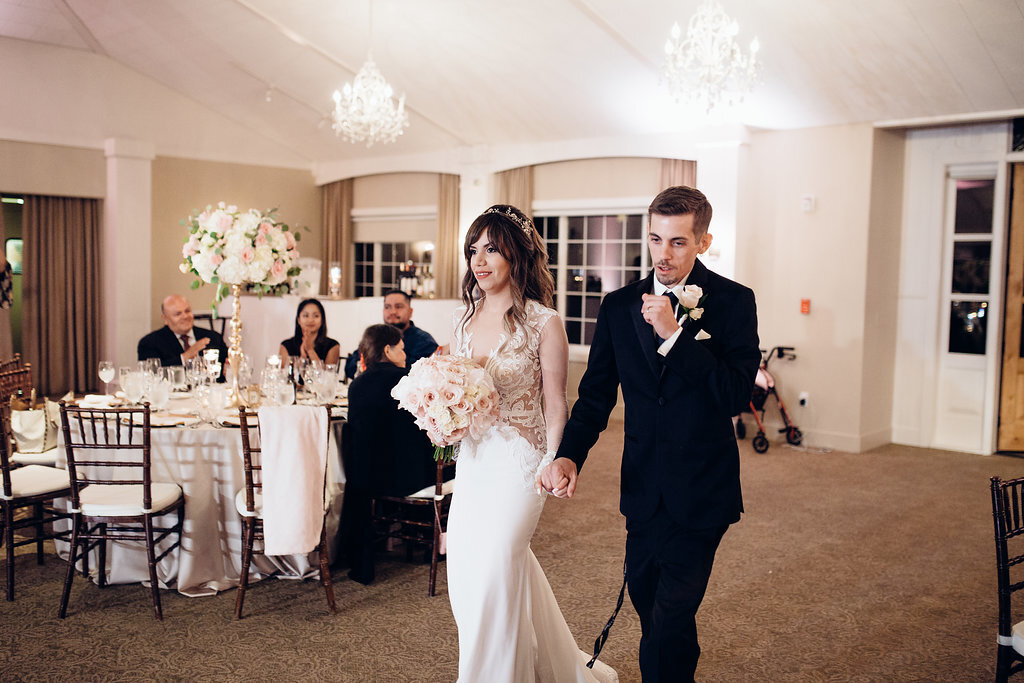 Wedding Photograph Of Bride in Dress And Groom In Black Suit Inside The Reception Hall Los Angeles