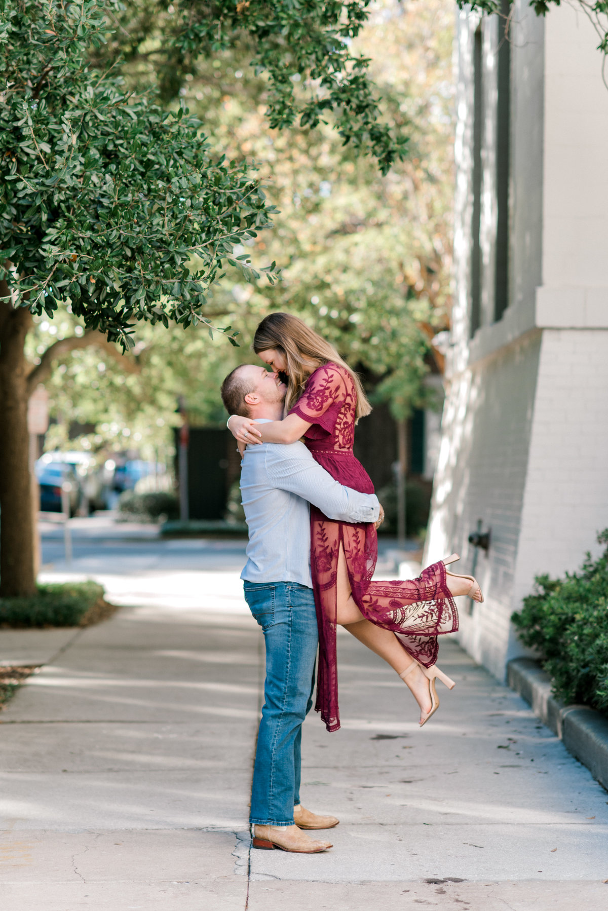 Guy lifts girl during  engagement session