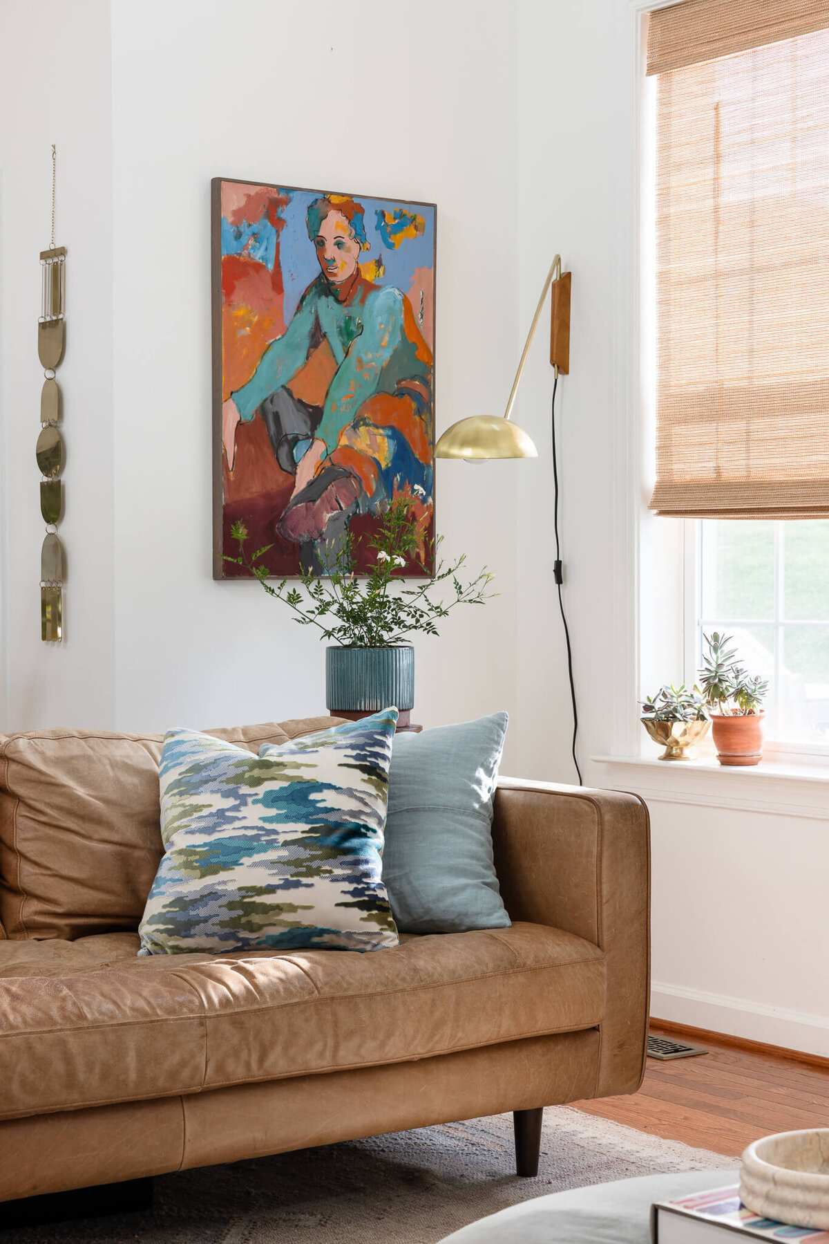 colorful-vintage-art-behind-leather-sofa