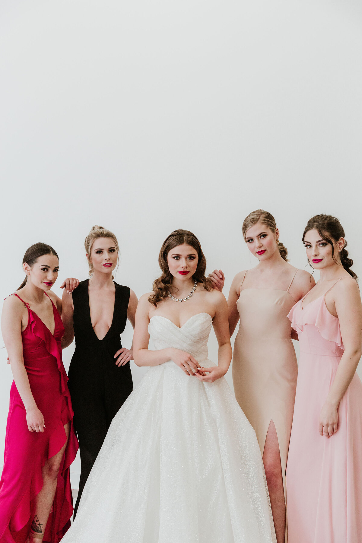 Trendy and elegant bride, bridesmaids wearing pink, black, and peach bridesmaid dresses, from Cameo & Cufflinks, a contemporary bridal boutique based in Calgary, Alberta. Featured on the Brontë Bride Vendor Guide.