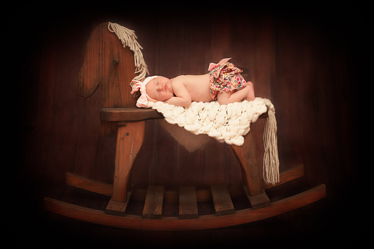 Newborn photography in East Texas Quitman. Fine art newborn on Rocking Horse