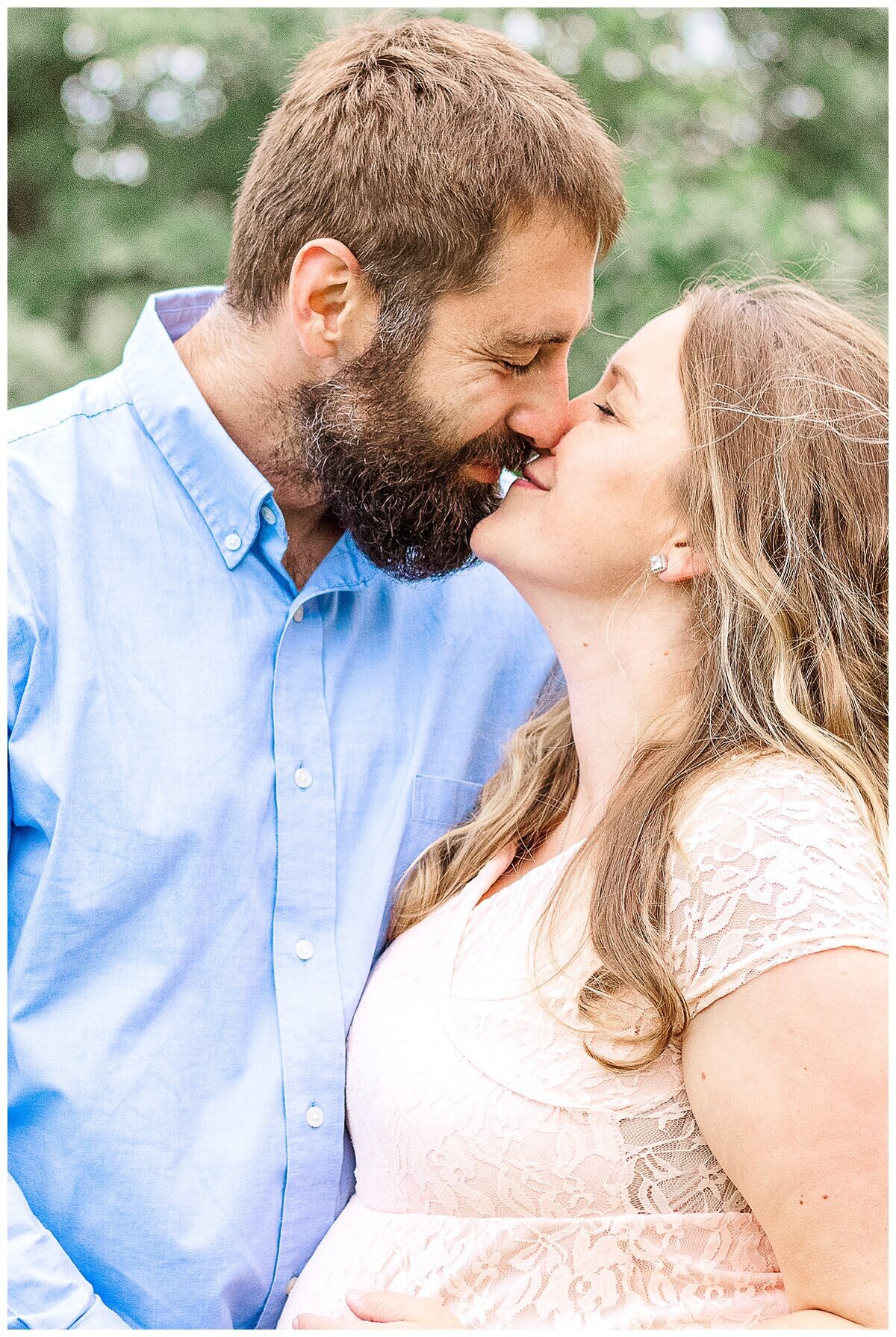 an outdoor Maternity Photography in Wexford where mom and dad sneak in a kiss while holding her baby belly