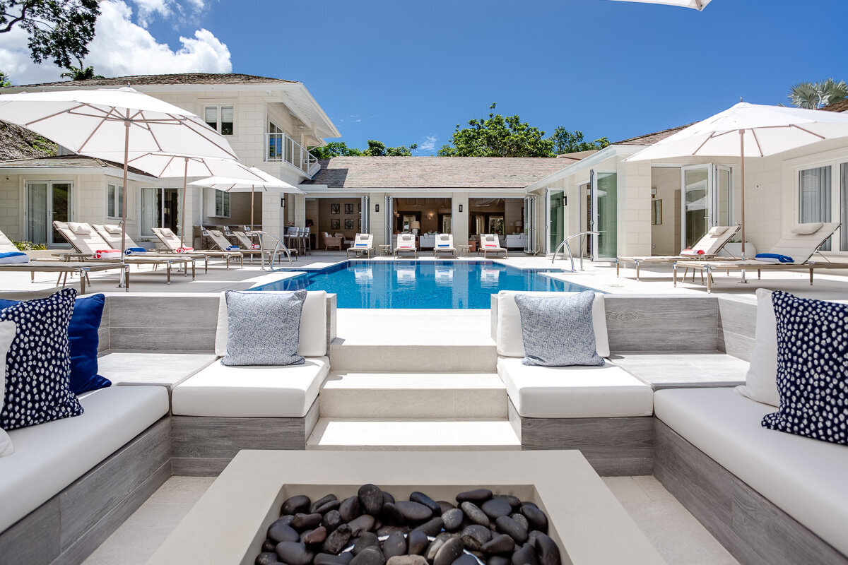 View from the firepit to the main villa which was a recent interior design project in Barbados