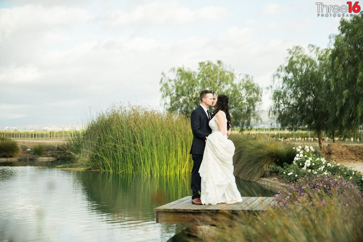 Bride and Groom share an intimate moment on a lake dock
