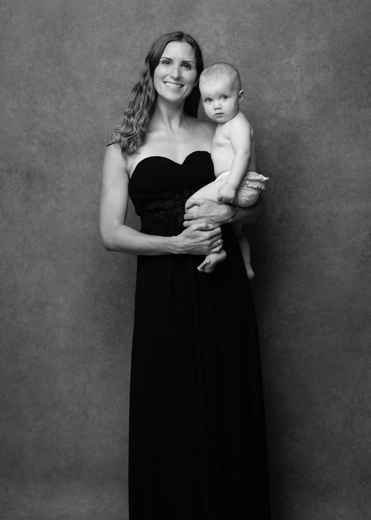 Mother-in-long-black-dress-with-baby