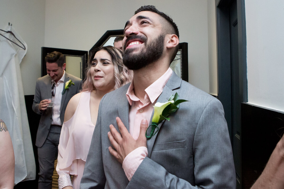 Groom clutches his chest and weeps seeing bride first look New York wedding photographer Milestone Images