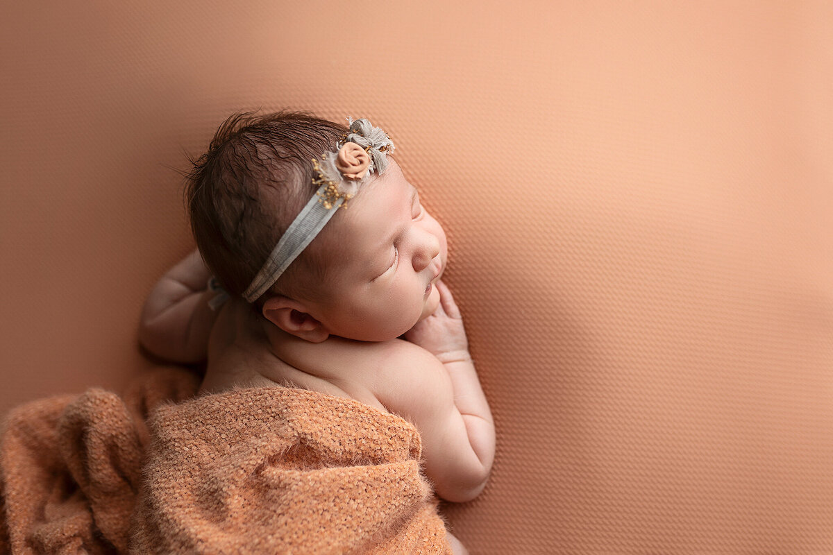 Profile image of a three week old baby girl.