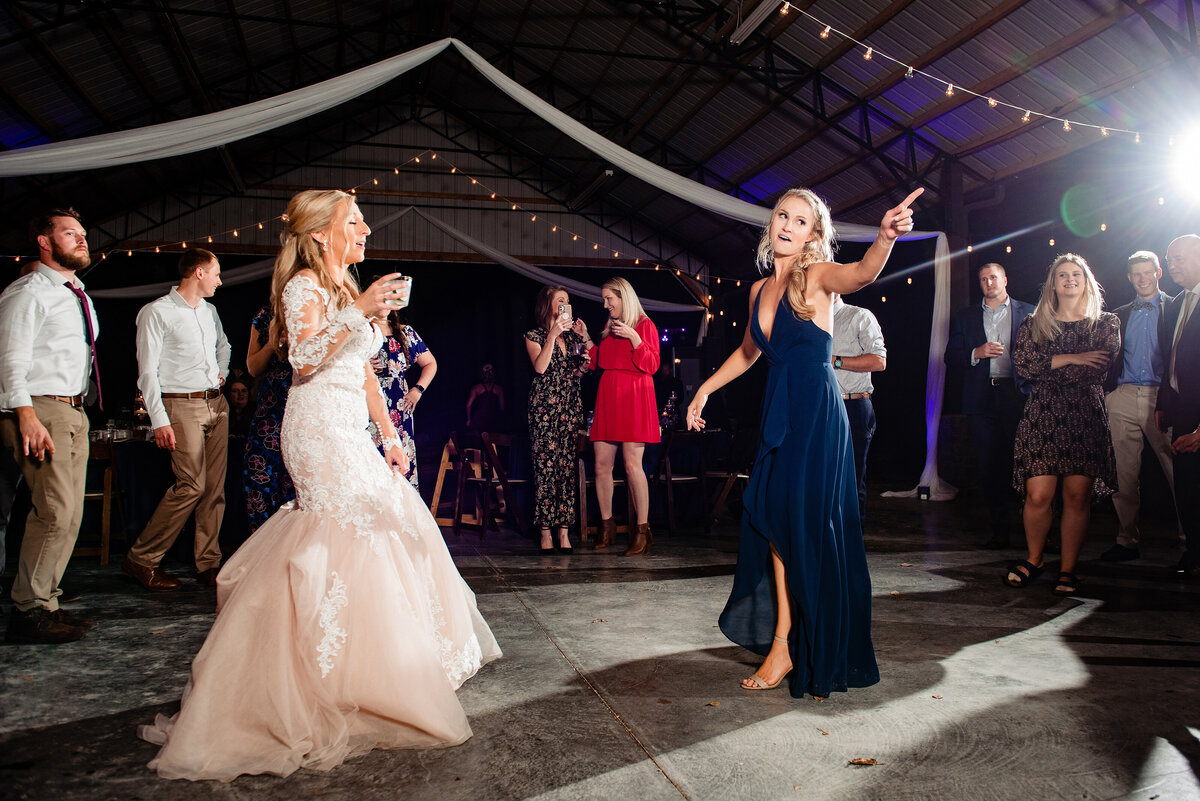 Maid of honor dancing with bride during reception