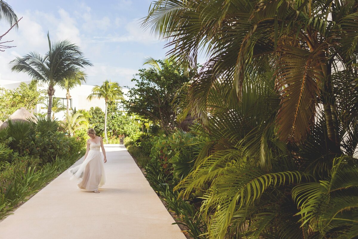 Bride walking down path at Finest Playa Mujeres before wedding