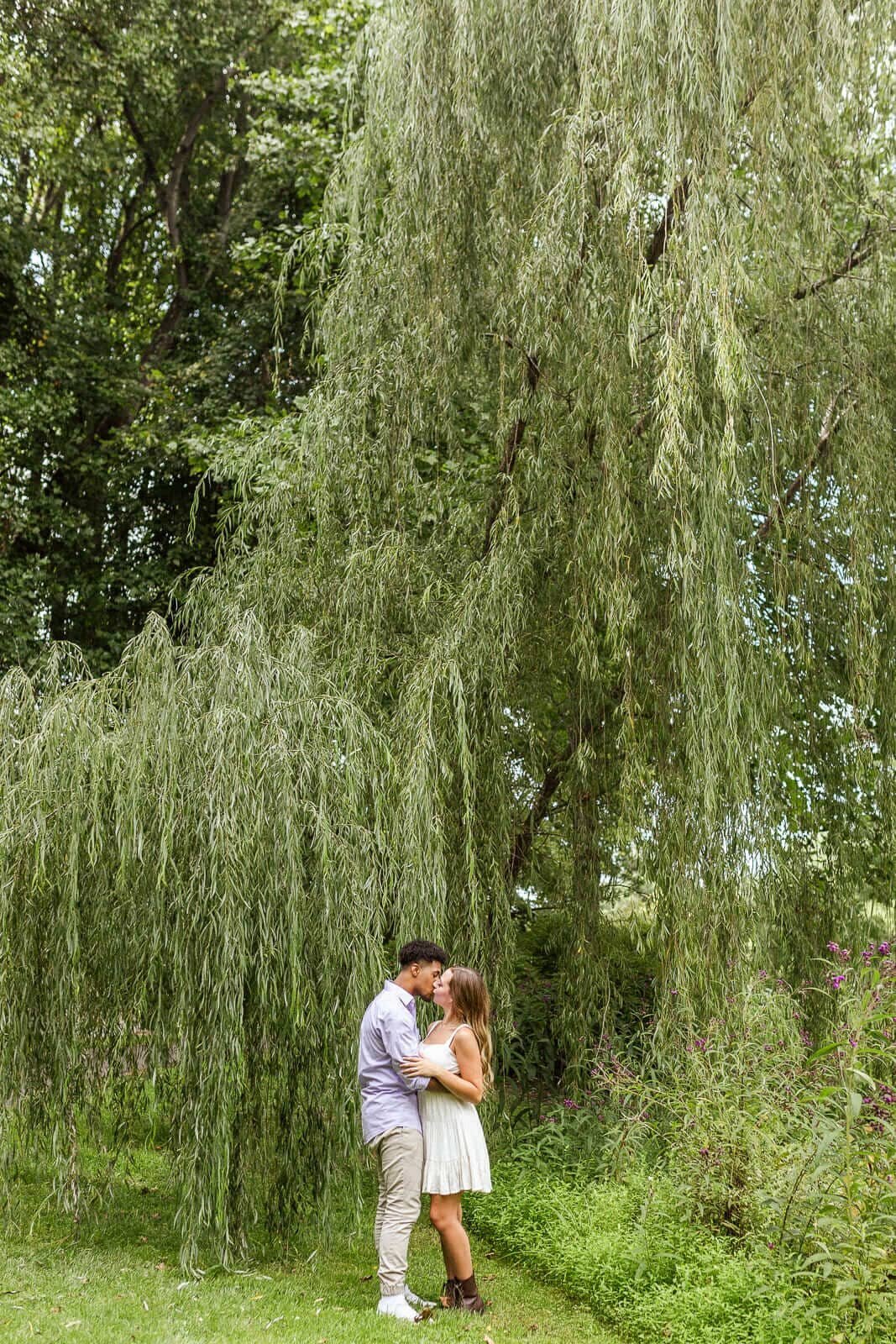 44-kara-loryn-photography-engaged-couple-kissing-by-a-tree